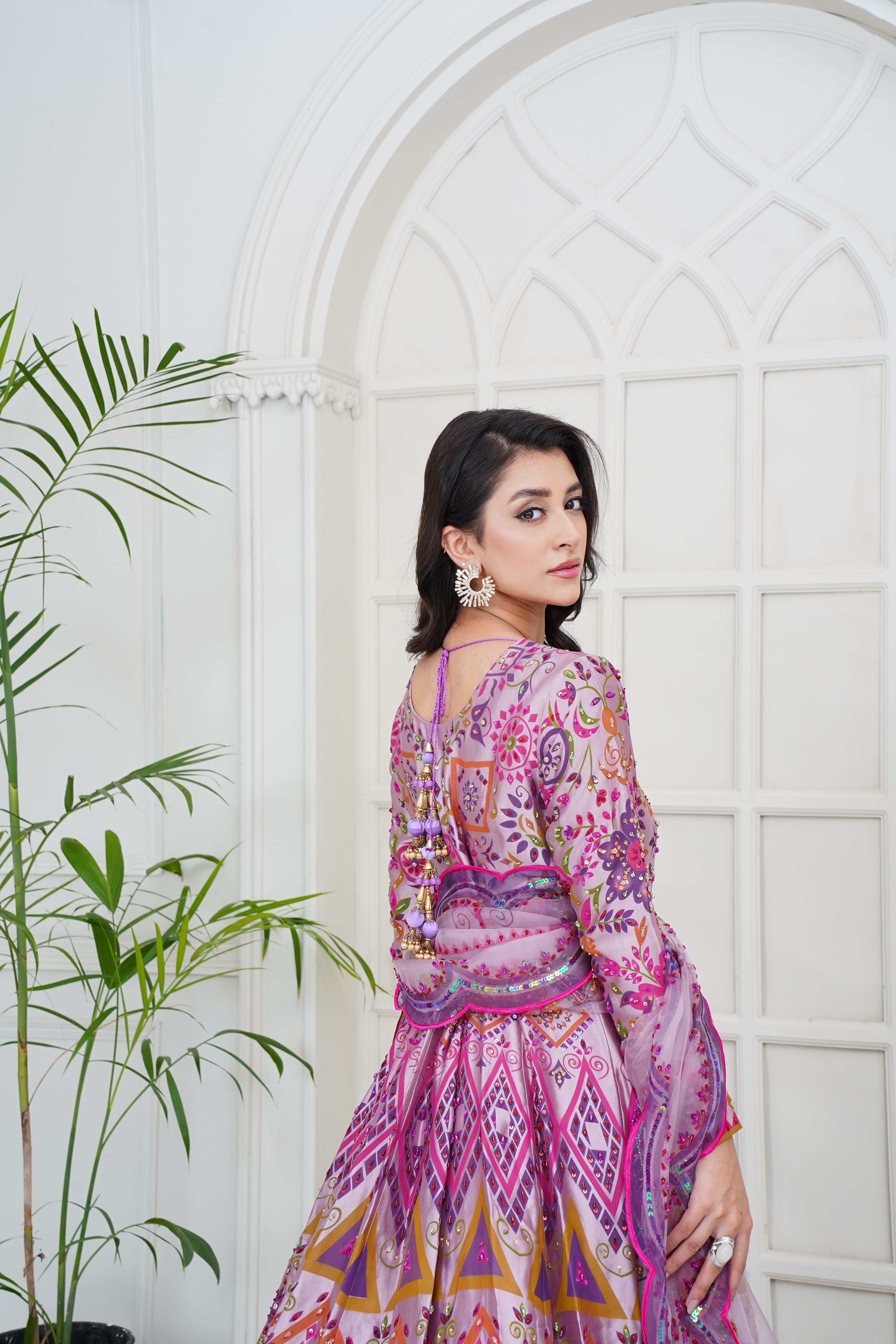 Stunning portrait of a female model in vibrant ethnic wear indoors.