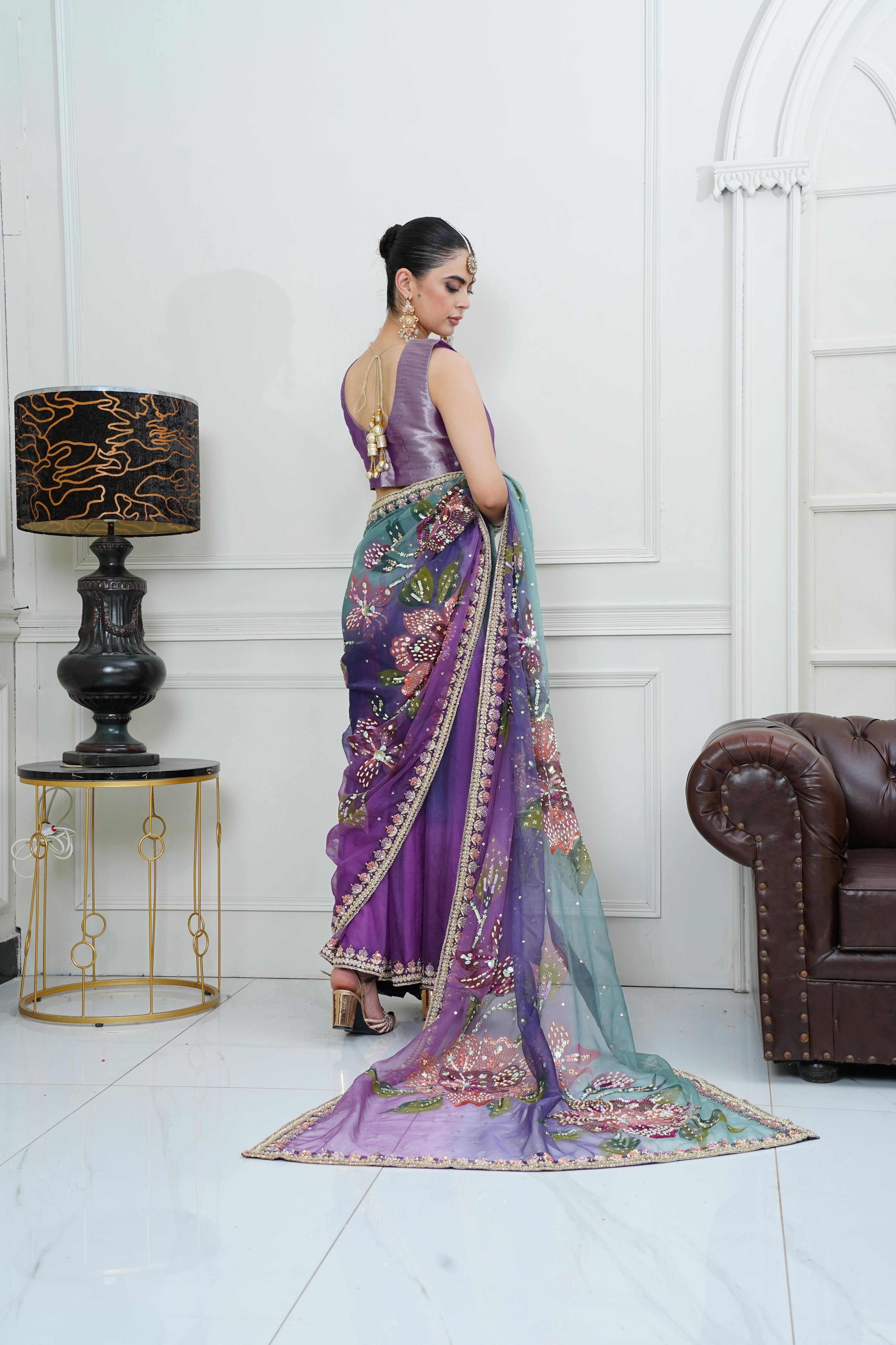 Elegant fashion model in a vibrant sari, showcasing traditional eastern attire indoors.