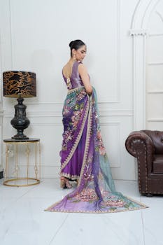 Elegant fashion model in a vibrant sari, showcasing traditional eastern attire indoors.