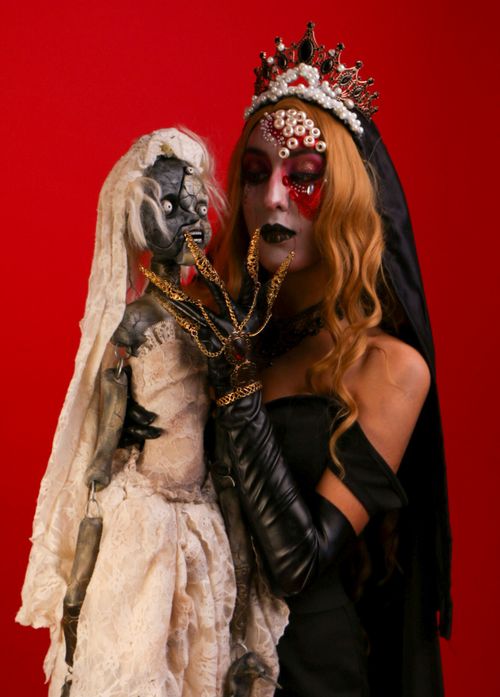 Free A striking gothic-inspired portrait with a dramatic expression and artistic makeup. Stock Photo