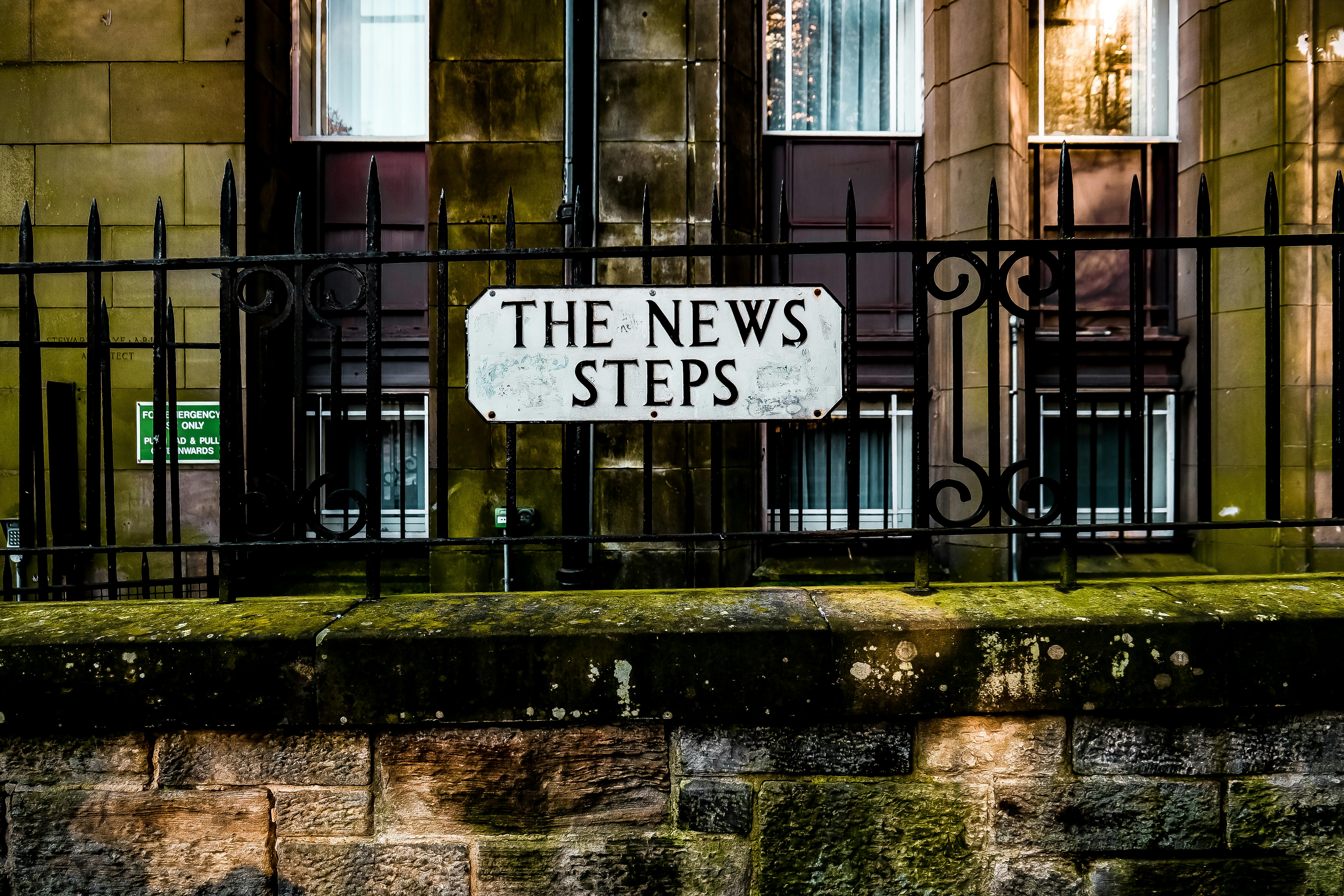 historic urban scene with iron fence and sign