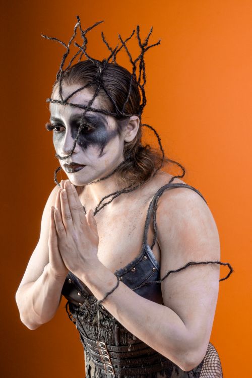 Free Creative Halloween makeup featuring a gothic look against an orange backdrop. Stock Photo