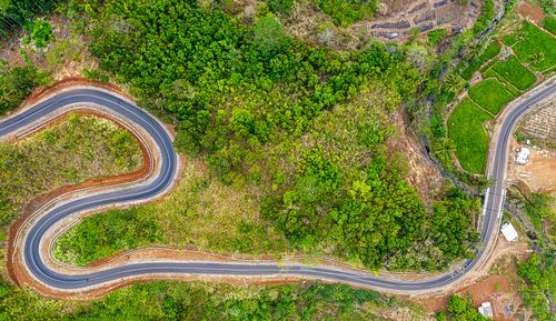 Free Captivating aerial shot of winding road through lush greenery in West Java, Indonesia. Stock Photo