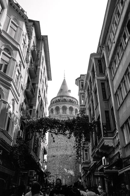 Black and white street view of Galata Tower in İstanbul, Türkiye.