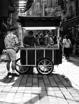 A captivating black and white photo of a bustling street market in İstanbul, Türkiye.