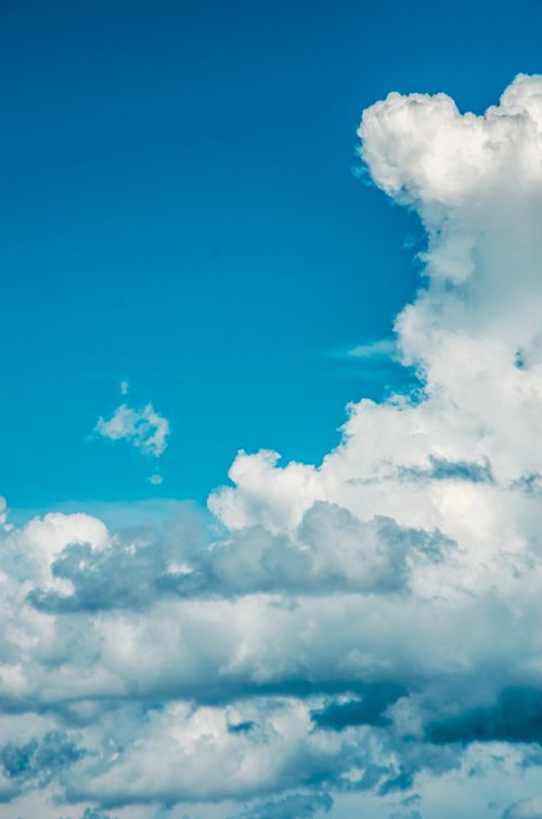 Free Peaceful sky full of cumulus clouds against a bright blue background, evoking serenity. Stock Photo