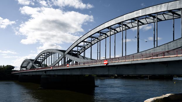 A stunning steel arch bridge in Hamburg under a clear blue sky, symbolizing modern architecture., free online jigsaw puzzle on JigsawPuzzlesFreeOnline.org