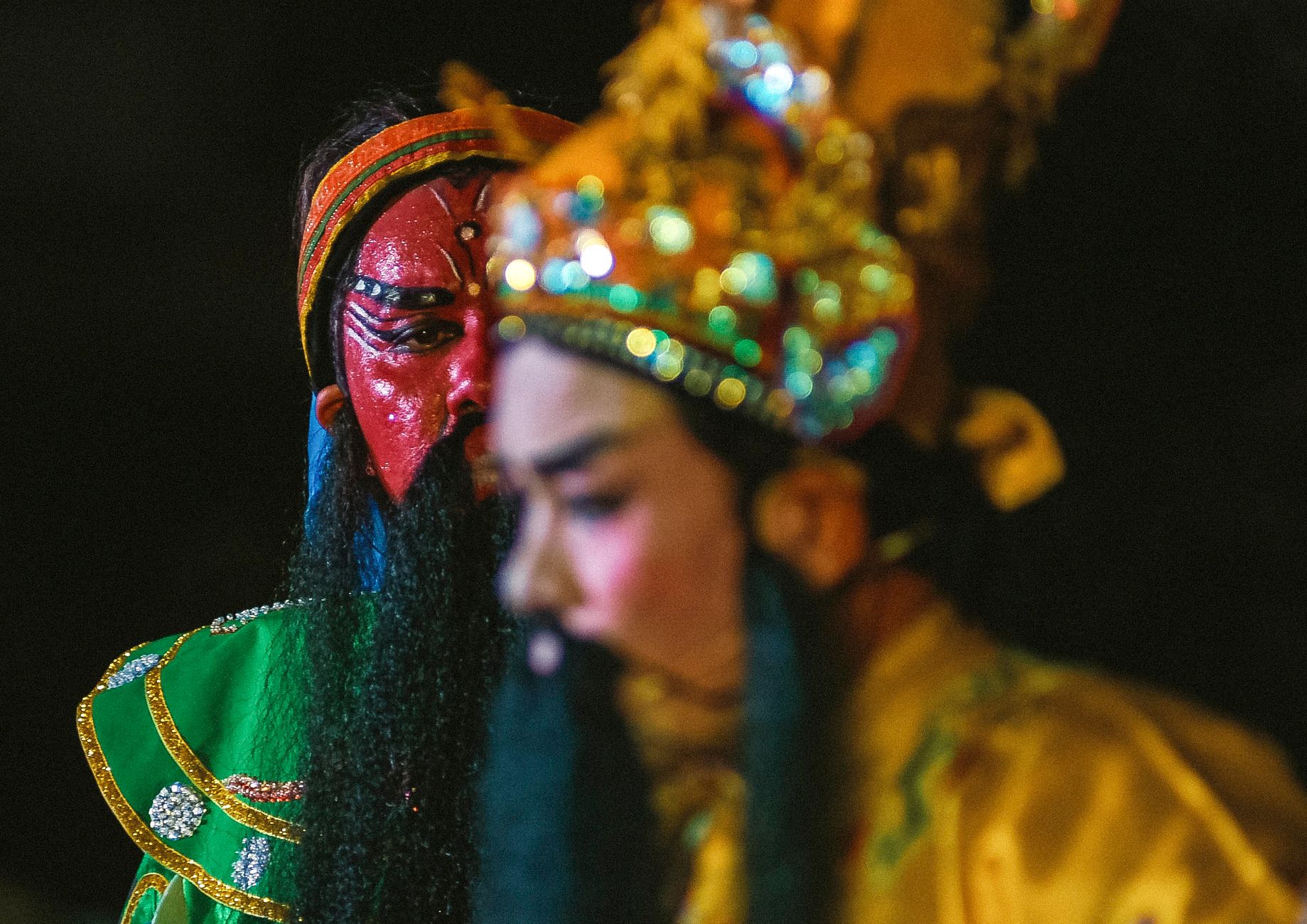 Vivid capture of performers in traditional Chinese opera costumes and makeup, showcasing cultural heritage.