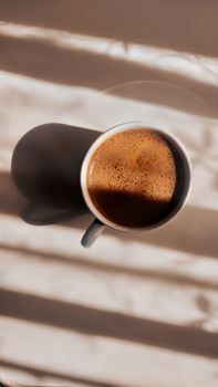 A warm, frothy Turkish coffee cup bathed in sunlight, creating a cozy atmosphere.