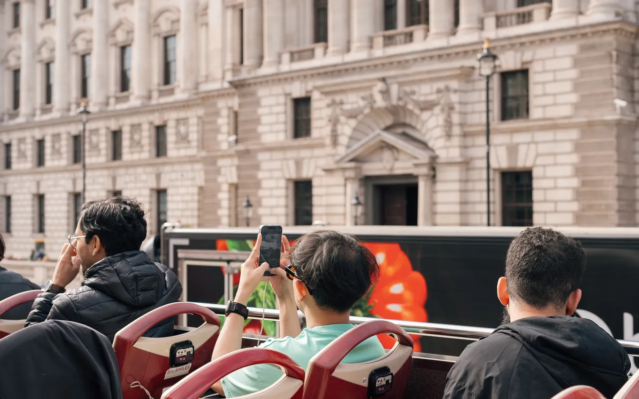 Visitors on an open-top sightseeing bus