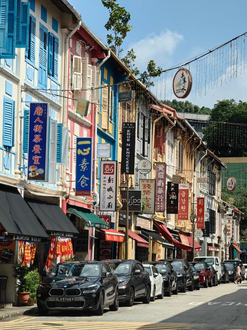 Free Colorful heritage buildings line a bustling street in Singapore's Chinatown. Stock Photo