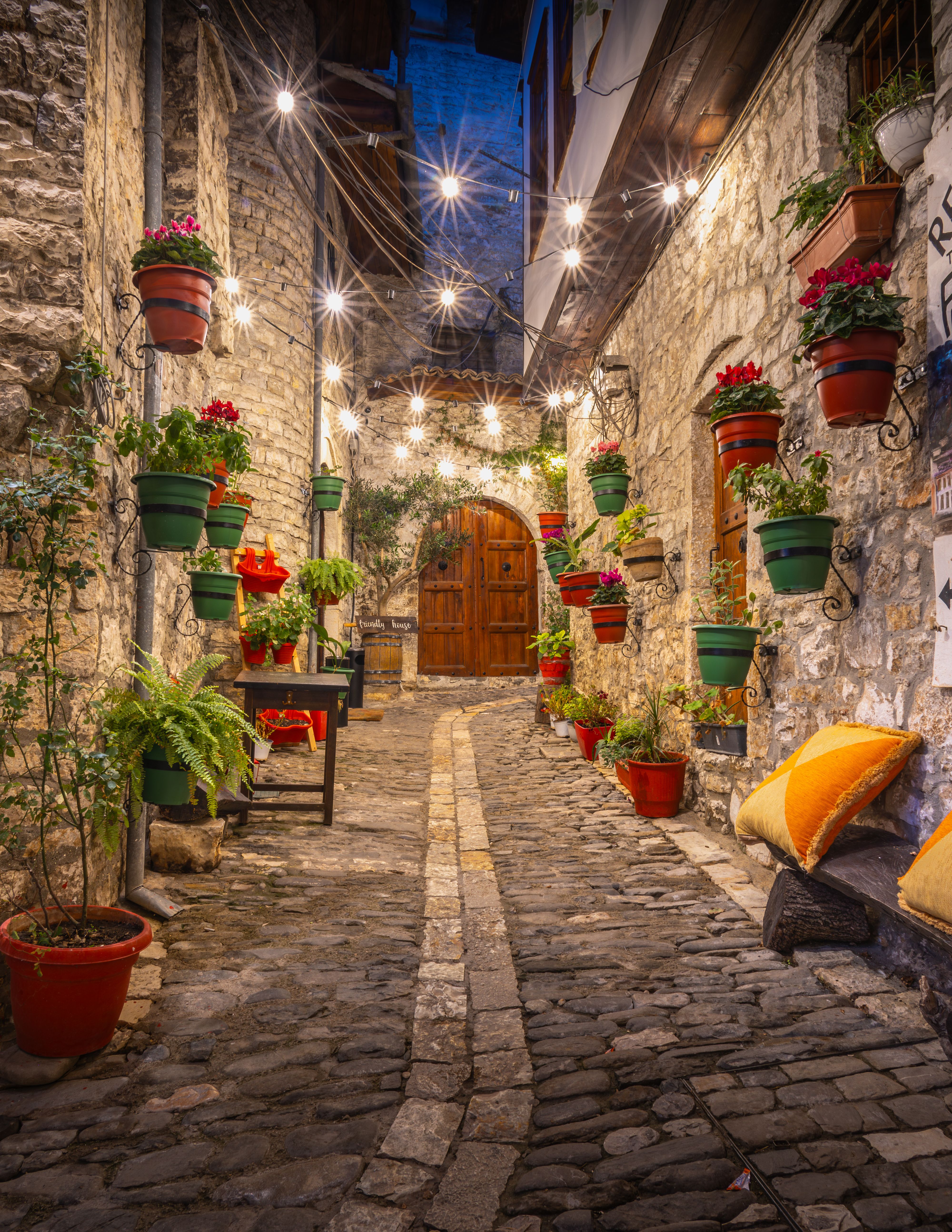 Charming Cobblestone Alleyway with String Lights at Night · Free Stock ...