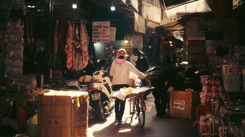 Free Vibrant market street with people and goods in Hà Nội, Vietnam Stock Photo