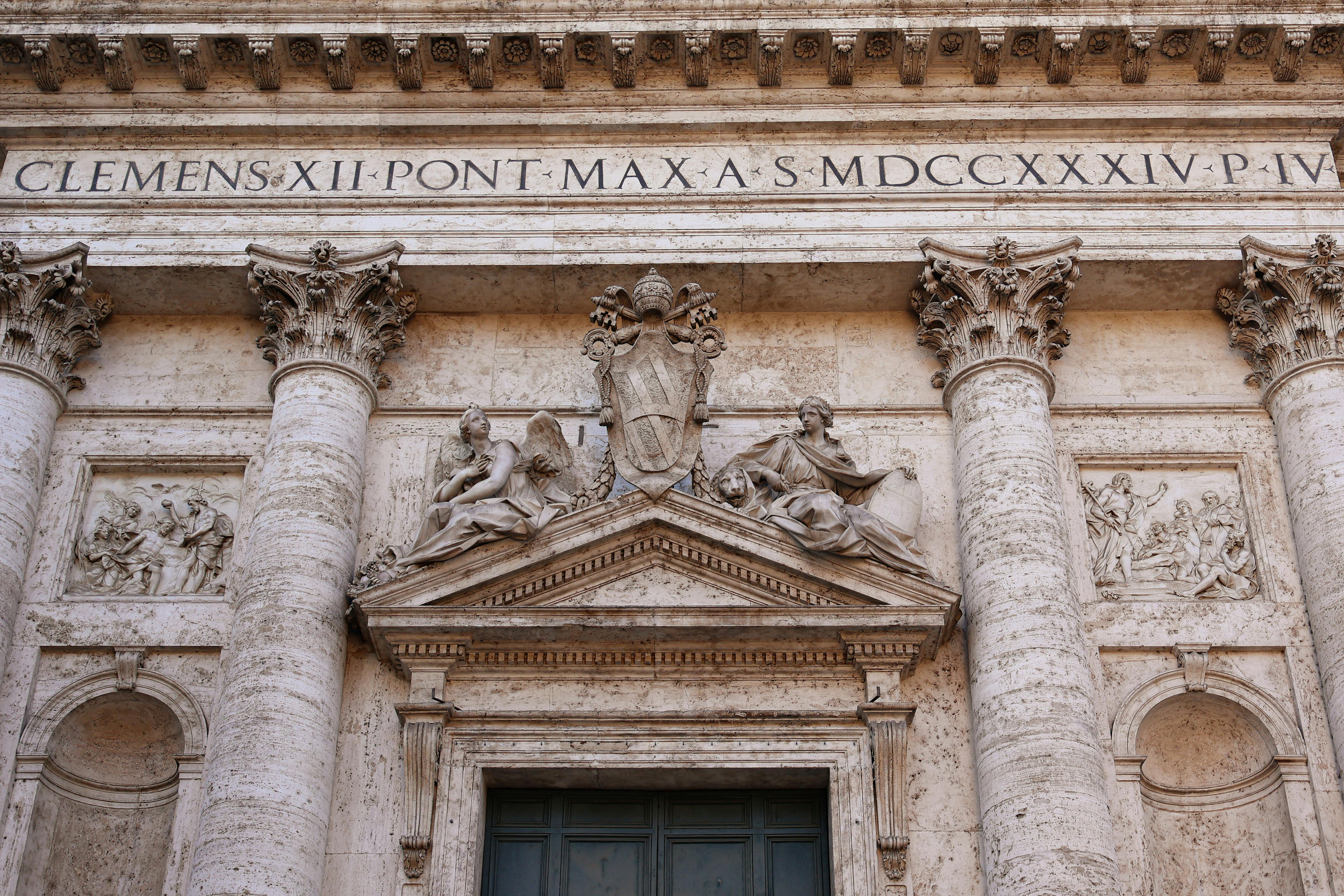Close-up of a Baroque church facade in Rome with artistic sculptures and detailed architecture.