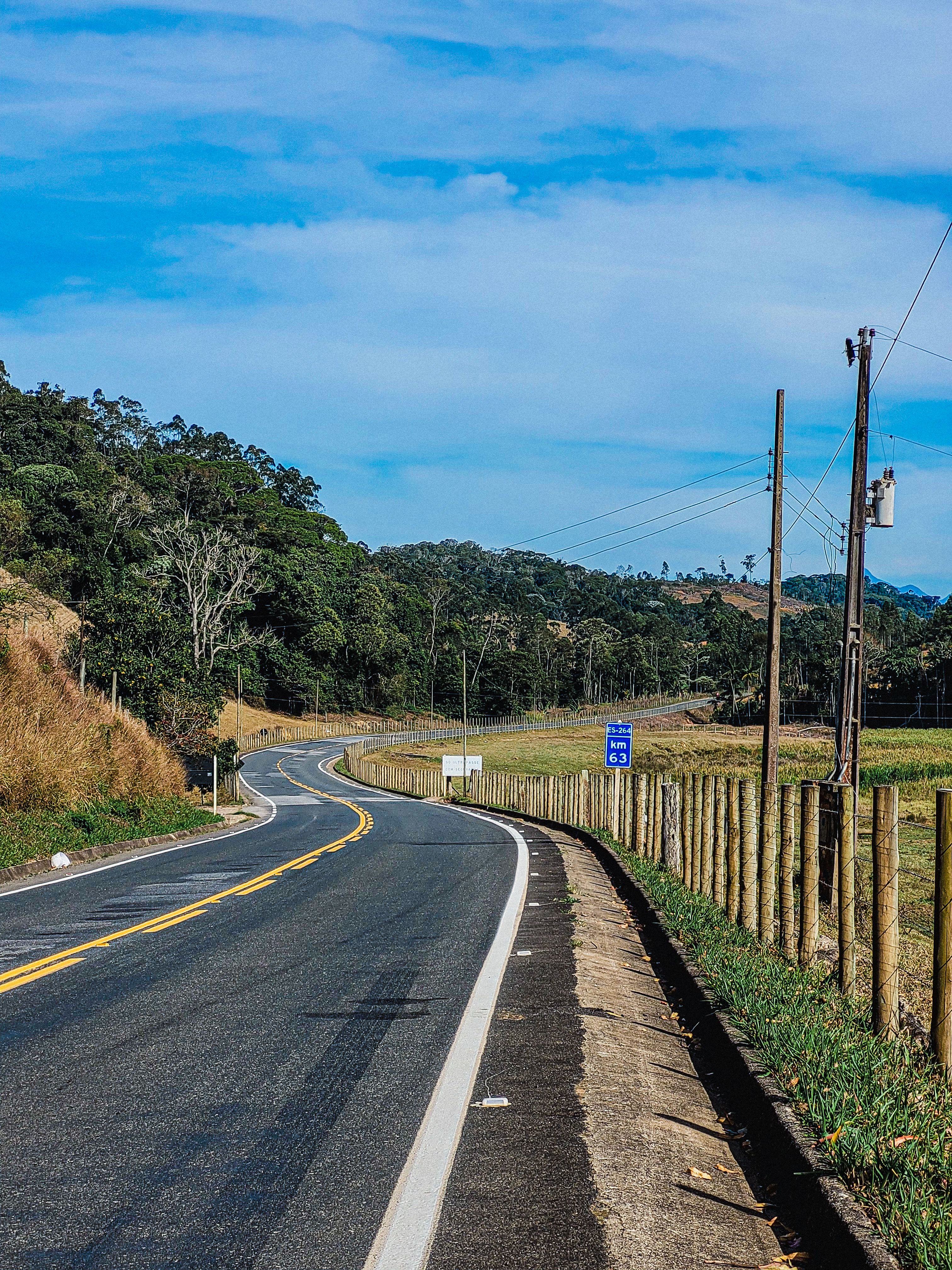 Scenic Country Road with Lush Greenery · Free Stock Photo
