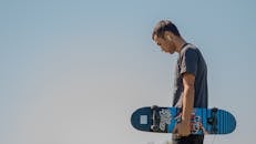 Man Holding A Skateboard