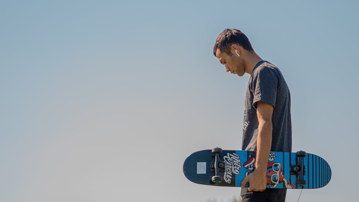 Free Man Holding A Skateboard Stock Photo