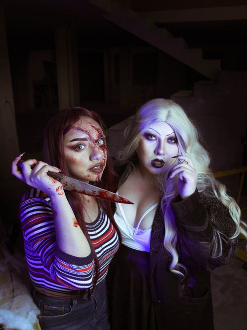 Free Two adults in gothic costumes with dramatic makeup and lighting. Stock Photo