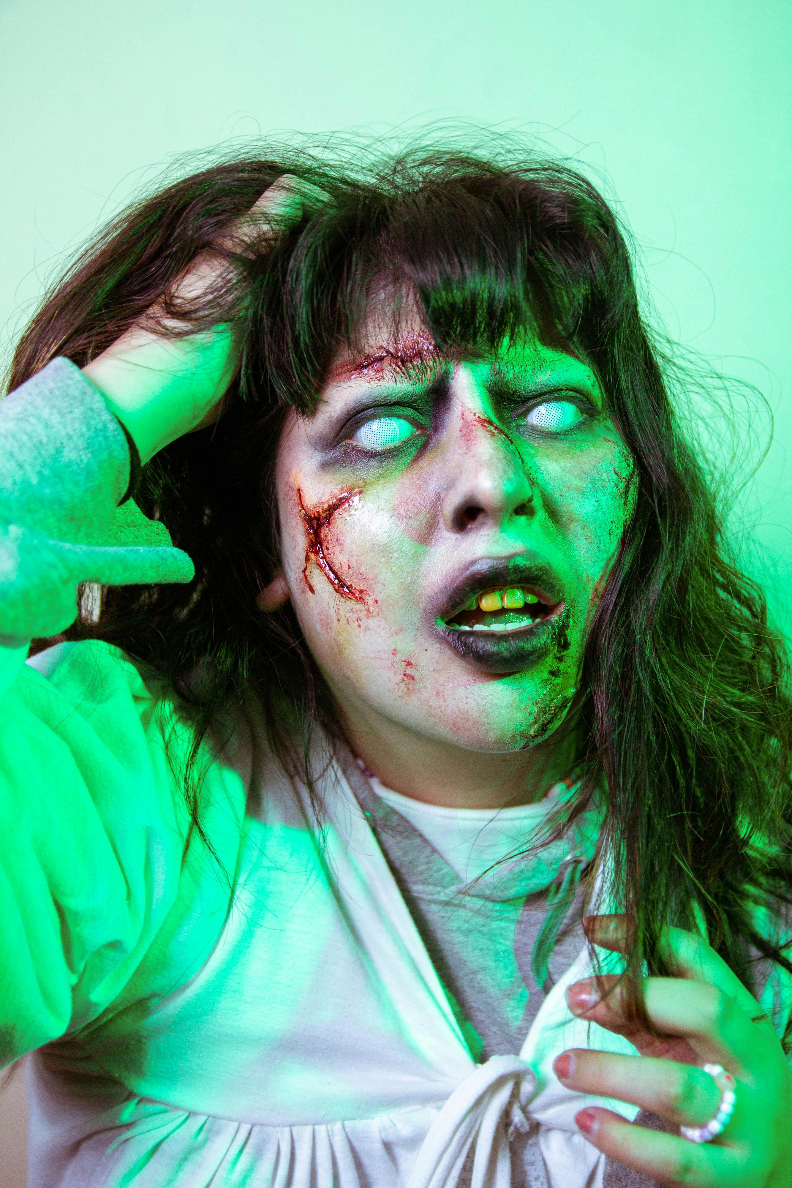 Scary zombie-themed portrait with glowing eyes and special effects makeup for Halloween.