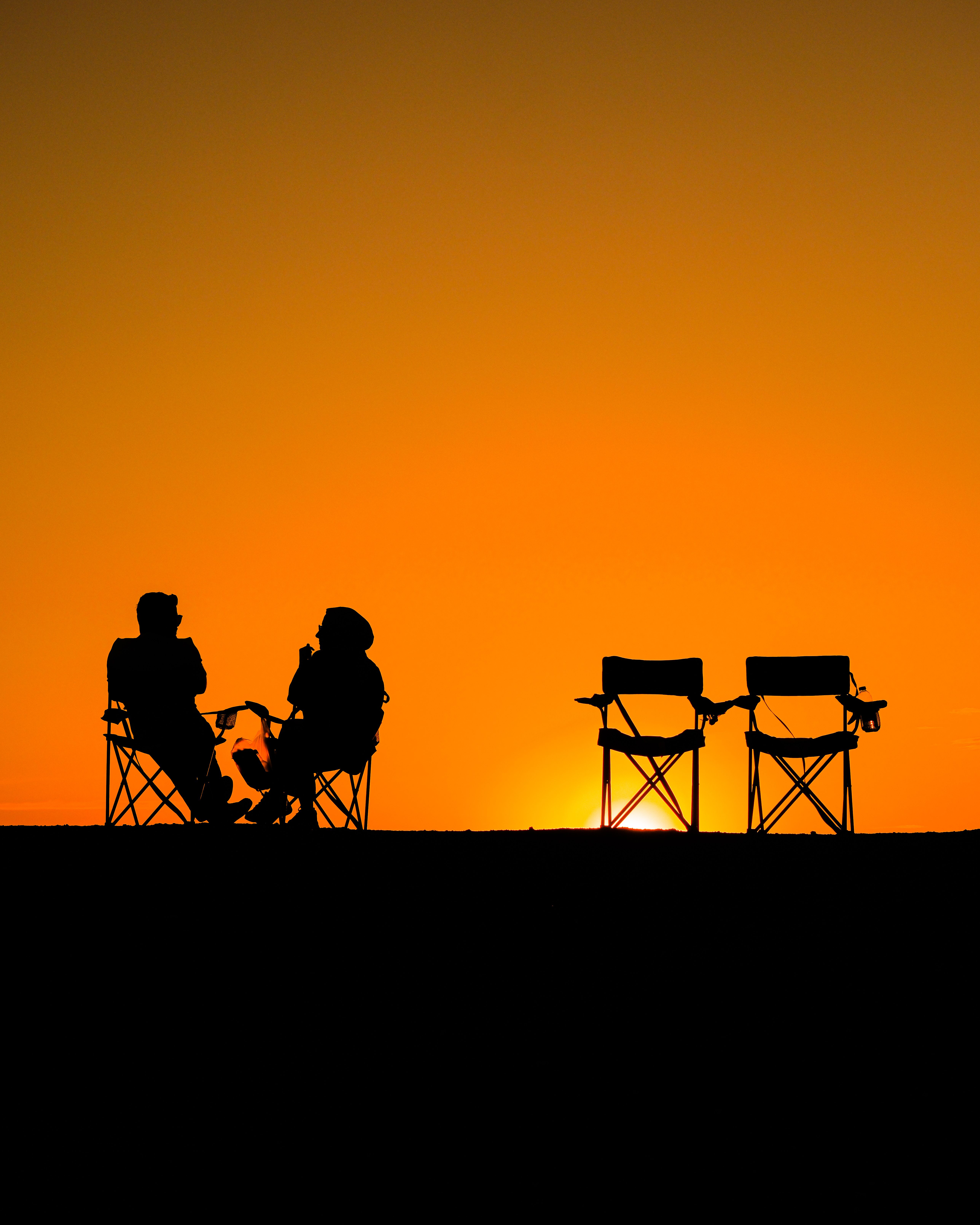 Sunset Silhouette of People Relaxing Outdoors · Free Stock Photo