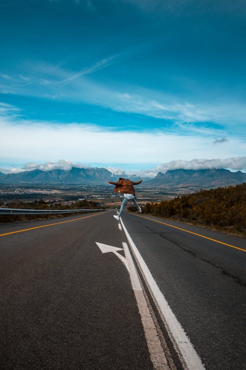 Free Person  Jumps On Road  Stock Photo