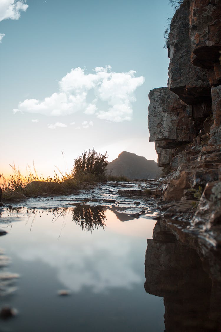 Reflection Of The Cliff And Cloud On Water Residue