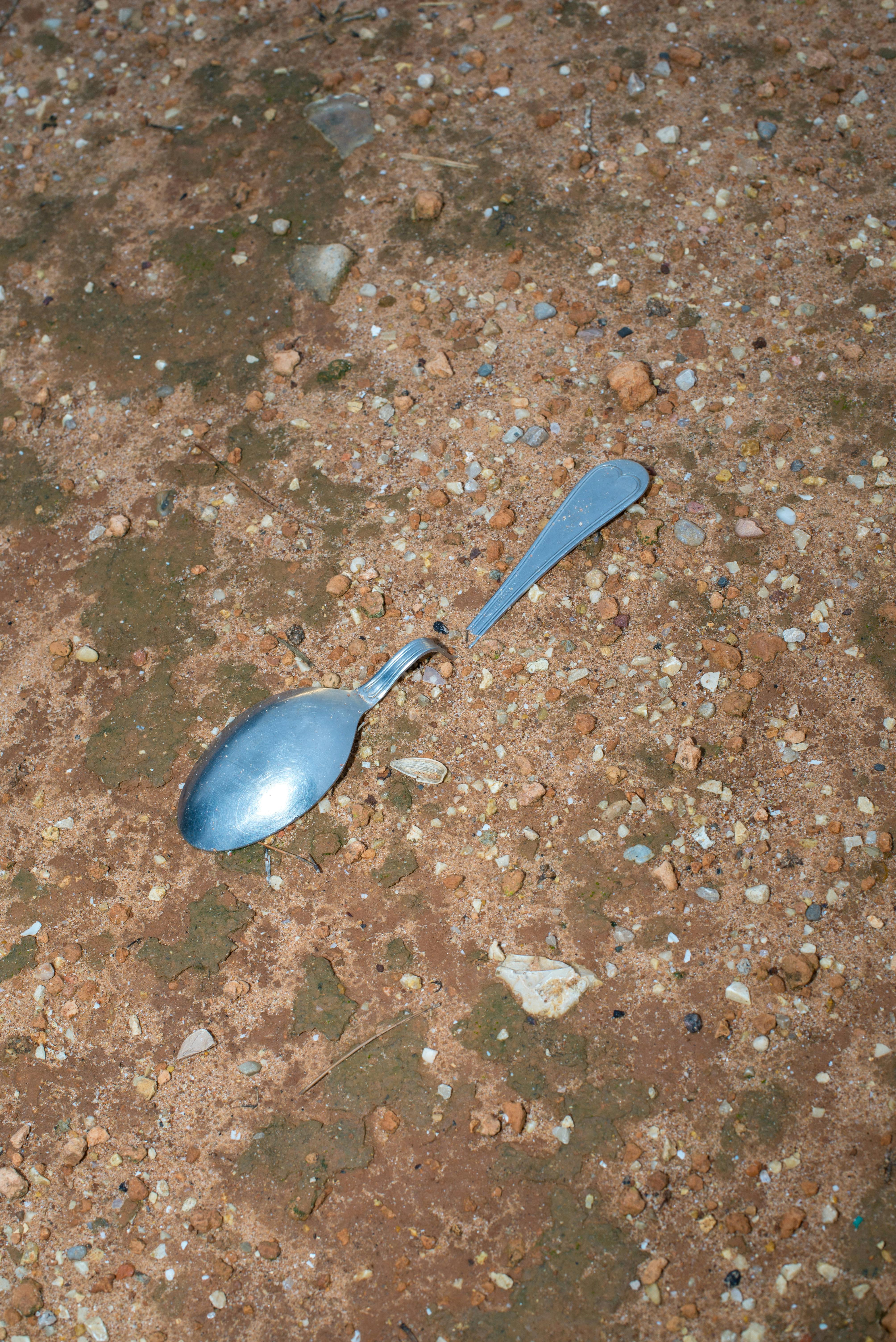 metal spoon on rough earth surface