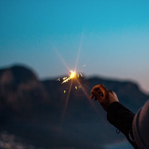 Free A Lit Flare Light On Hand Stock Photo