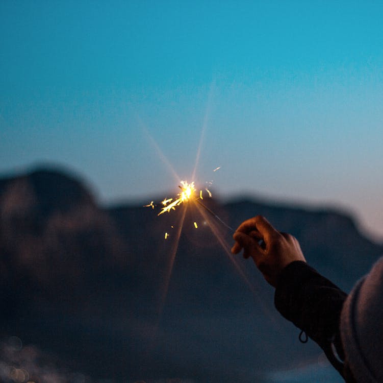 A Lit Flare Light On Hand