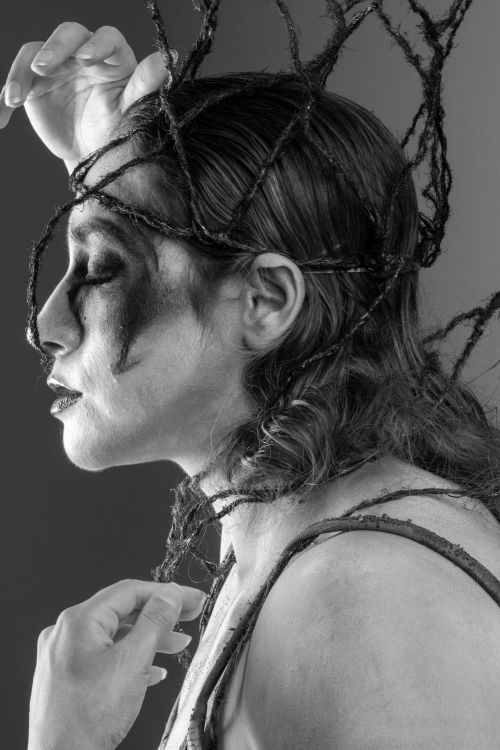 Free Black and white profile portrait featuring dramatic, artistic makeup and intricate hair design. Stock Photo