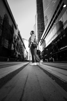 Artistic black and white photo of a woman standing in the Moscow business district.