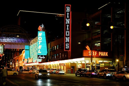 Neon lights illuminate Fremont Street, showcasing Binion's Hotel in Las Vegas at night.