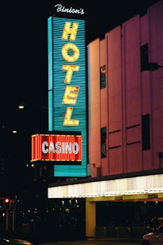 Neon-lit Casino and Hotel sign at night in downtown Las Vegas, showcasing vivid colors and urban nightlife.