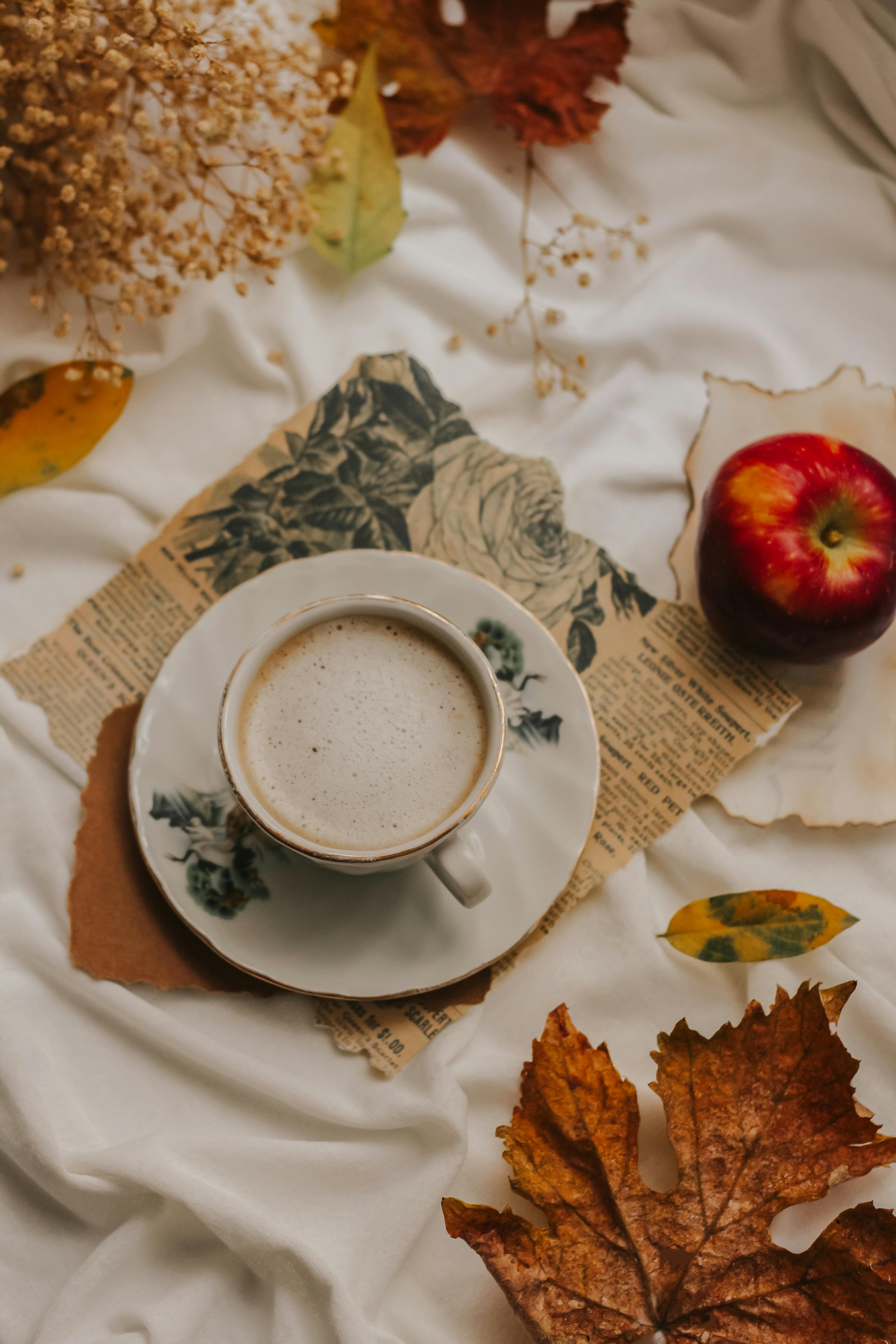 cozy autumn coffee with apple and leaves