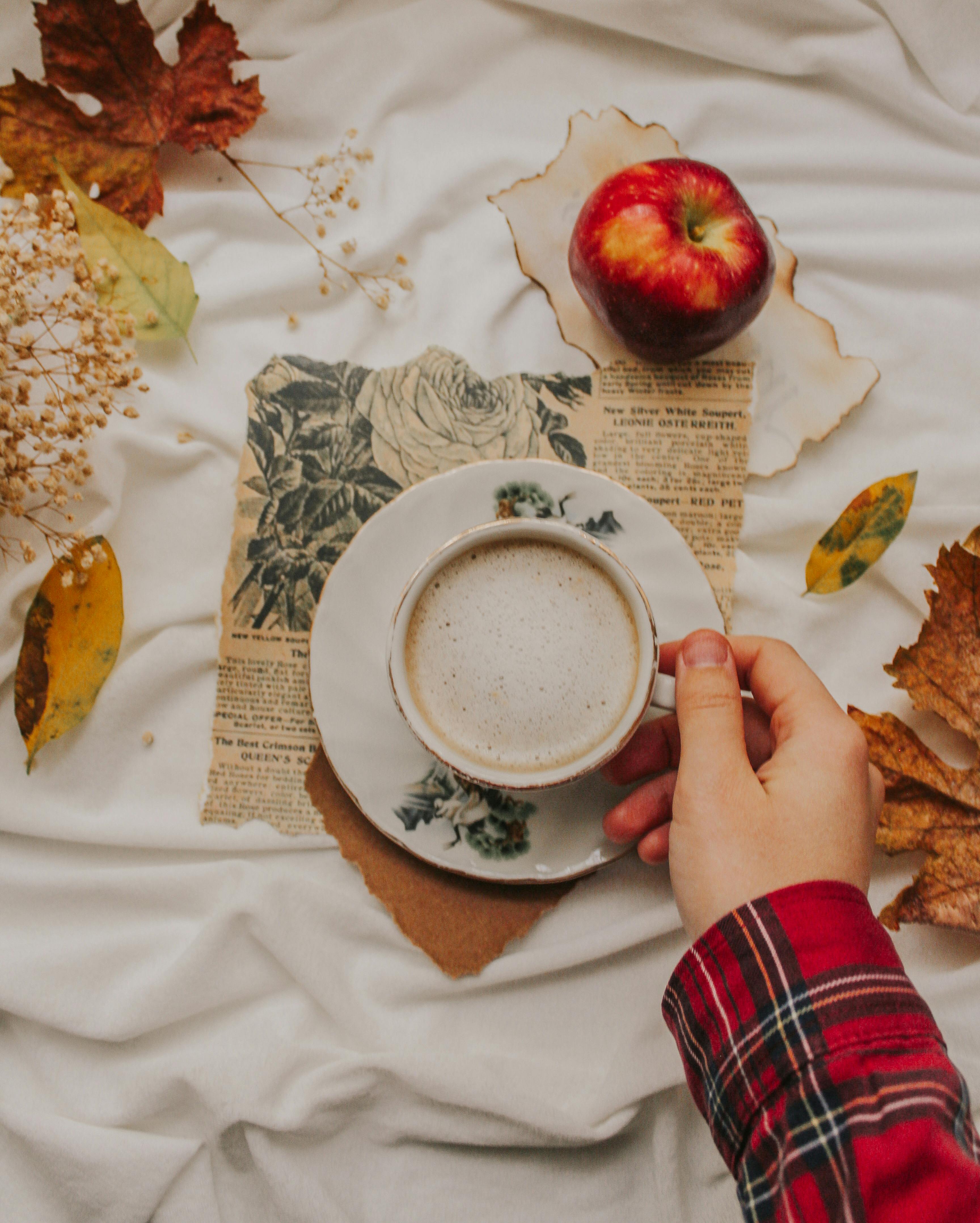 cozy autumn setting with coffee and apple