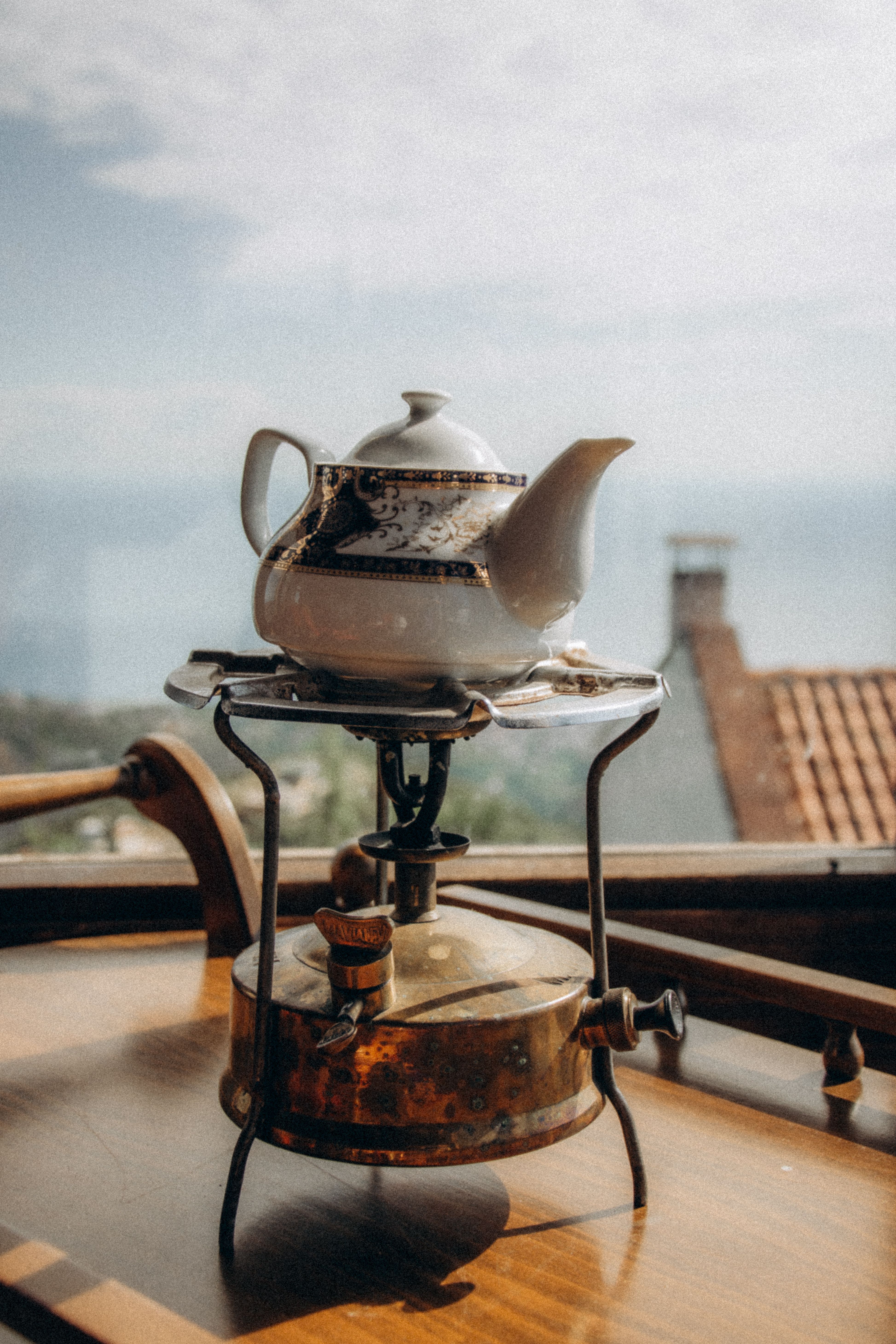 Vintage Teapot on Antique Stove by Window View · Free Stock Photo