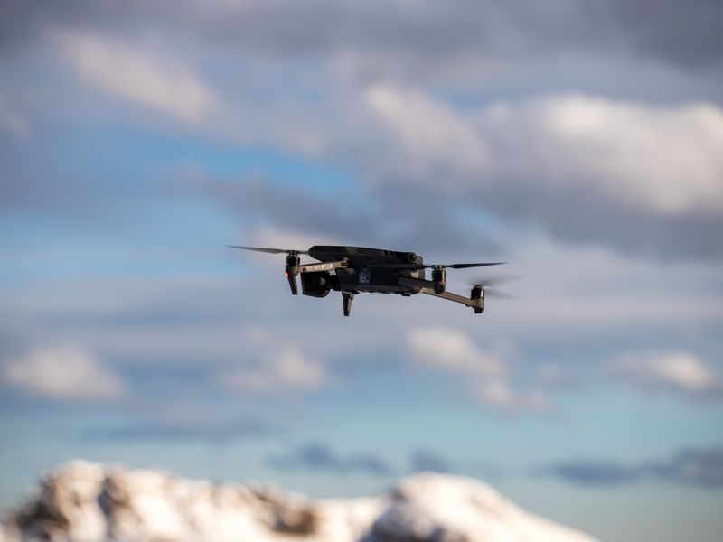 Aerial view of drone flying over snow-covered mountains