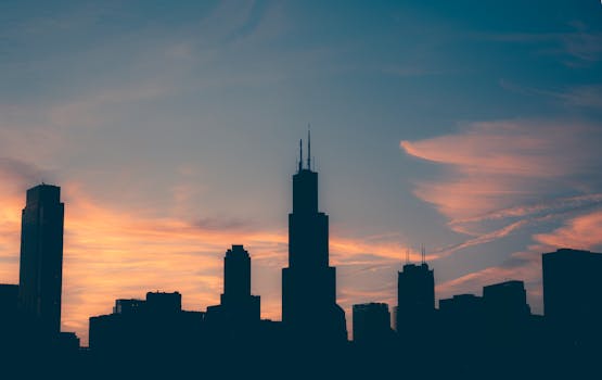 Silhouette of Chicago skyline during a vibrant sunset with colorful sky.