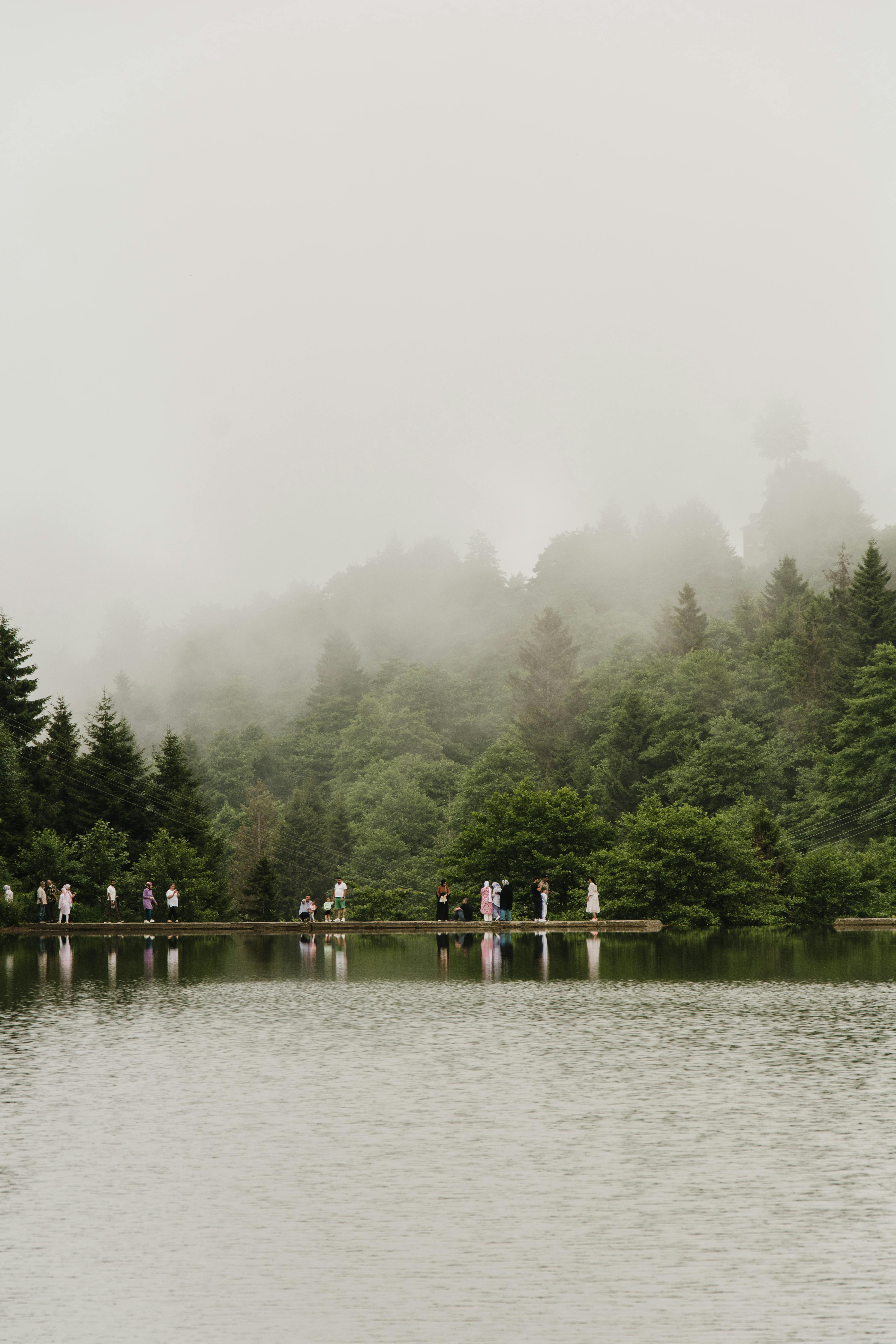 scenic lake with people on foggy day