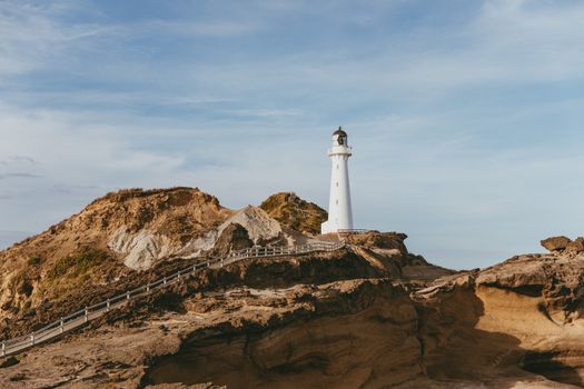 Scenic view of Castlepoint Lighthouse on a sunny day in New Zealand.