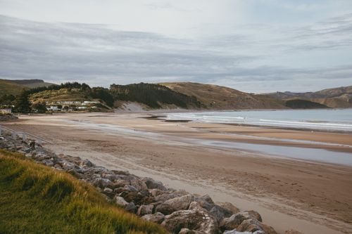Free Scenic view of Castlepoint beach and landscape, featuring serene ocean and hills. Stock Photo