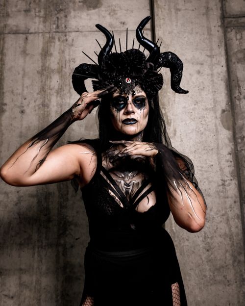 Free A captivating gothic-inspired cosplay featuring a model with horns and intricate face paint. Stock Photo
