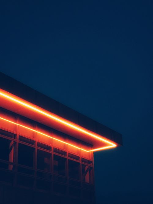 Free A modern building with striking neon lights against a deep blue night sky in Brazil. Stock Photo