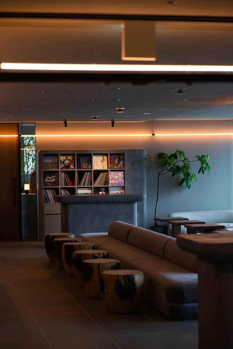 Elegant lounge space with ambient lighting and natural wooden seating elements, providing a cozy modern atmosphere.