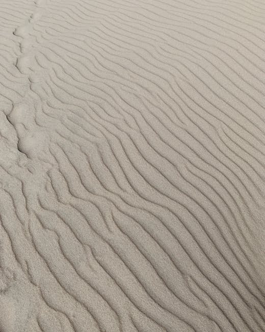 Capture of wavy sand patterns in Nida dunes, Lithuania, showcasing natural beauty.
