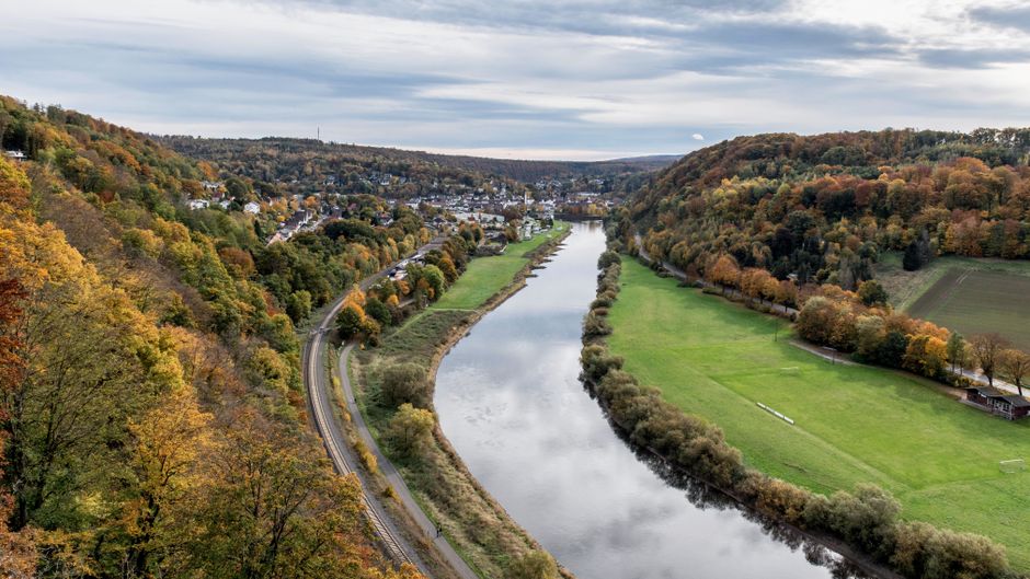 Aerial view of the Weser River and vibrant autumn landscape in Germany.