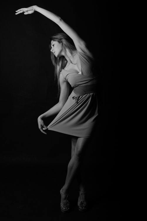 Free Graceful dancer striking an elegant pose in a black and white portrait. Stock Photo