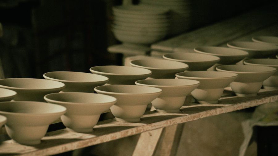 Rows of large ceramic water jars drying outside a pottery workshop in El-Ballas