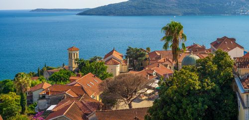 Free Aerial view of a charming Mediterranean village by the sea with red tiled roofs. Stock Photo
