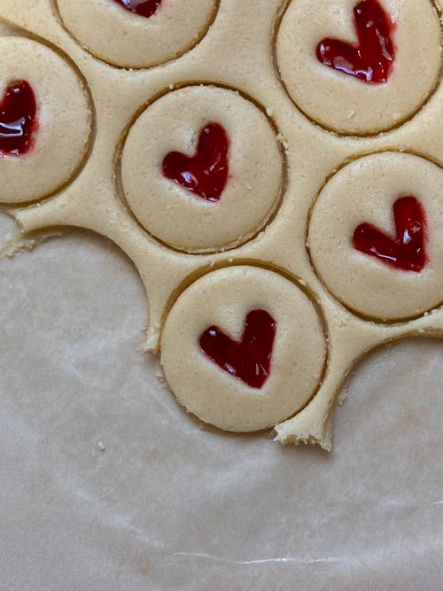 Free Heart-shaped jam cookies in dough with cutouts, perfect for baking themes. Stock Photo